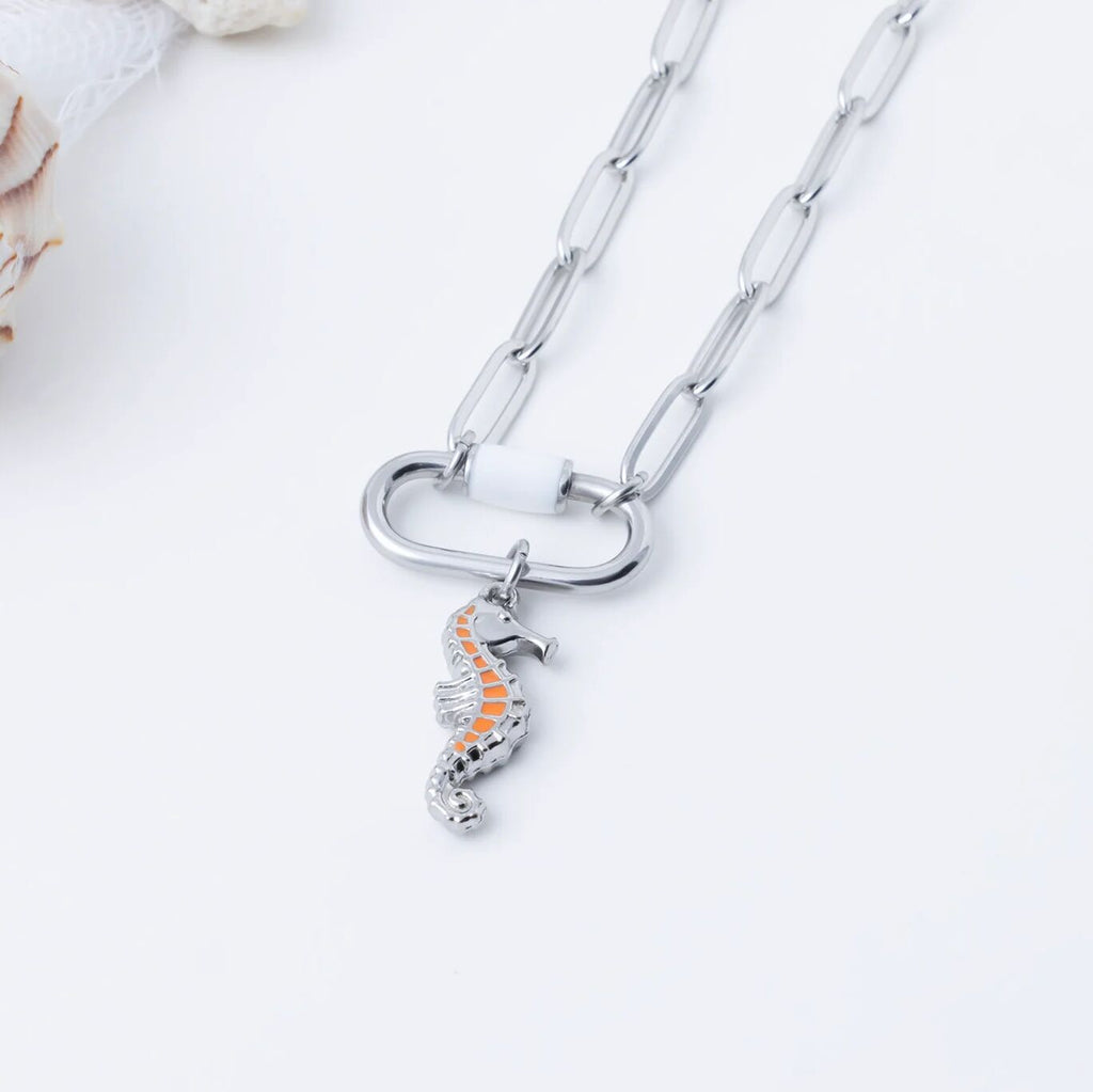 Silver necklace with a seahorse pendant on a light background