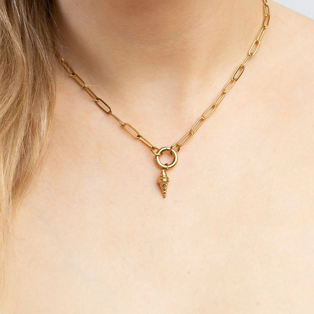 Gold chain necklace with an ice cream pendant on a person's neck
