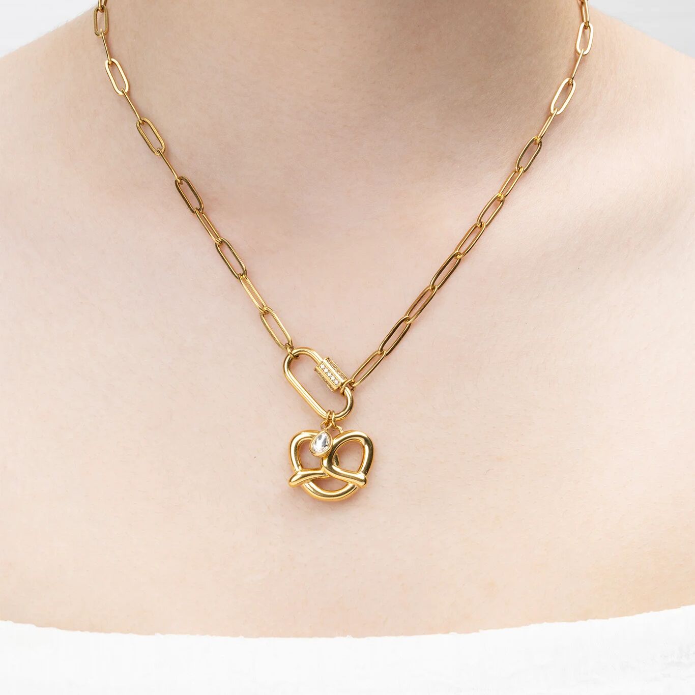 Gold necklace with a pretzel shaped pendant