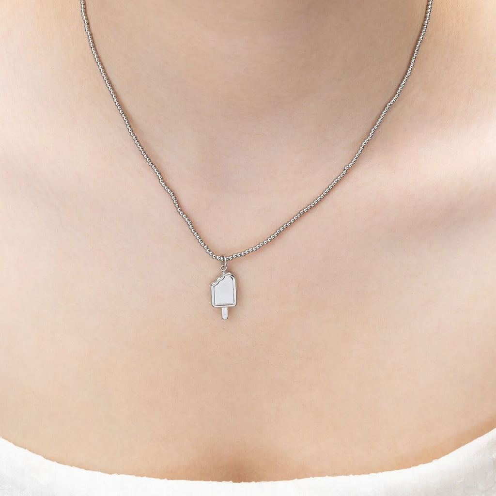 Silver necklace with a pendant on a person's neck