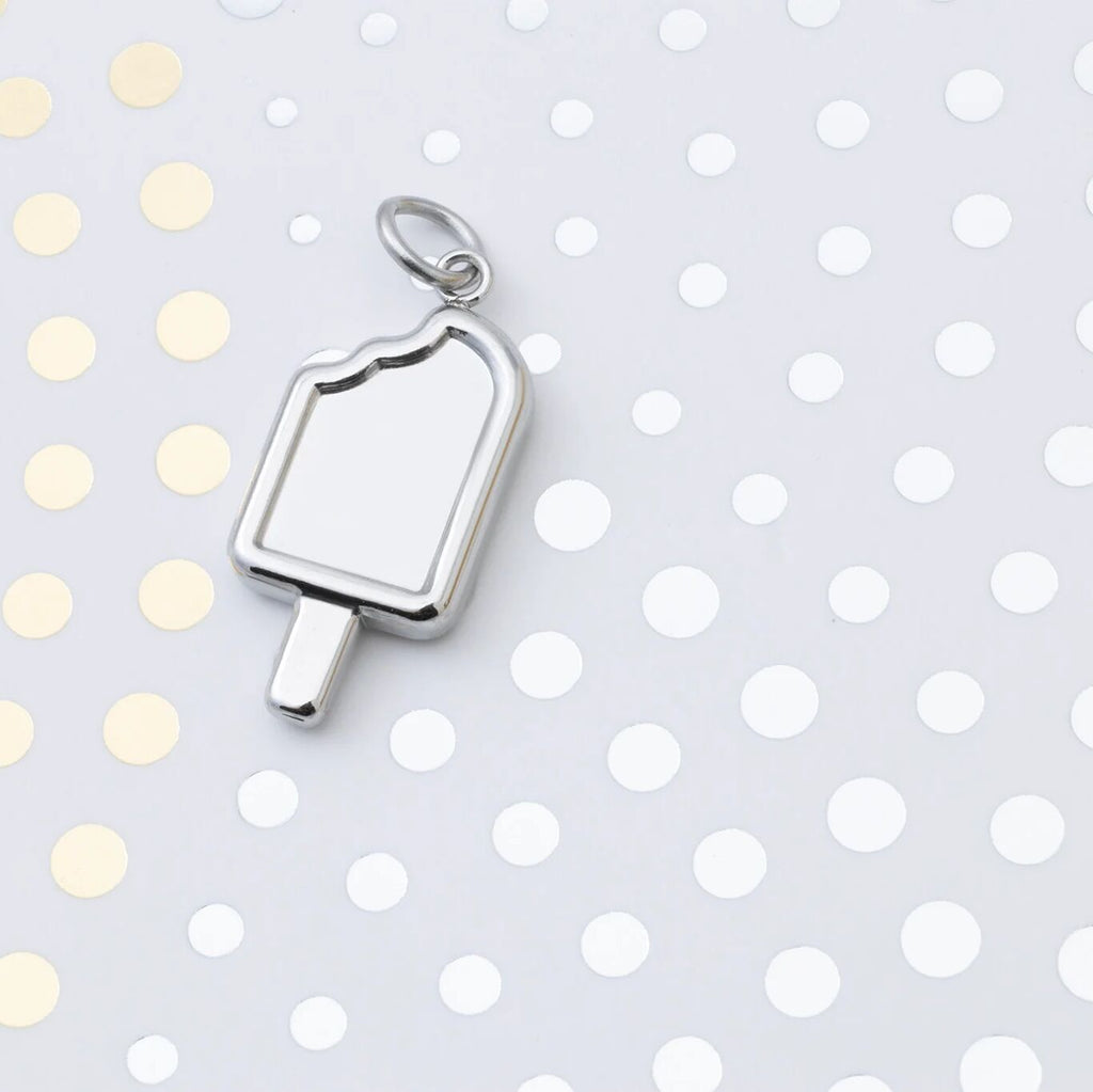 Silver popsicle pendant on a polka dot background