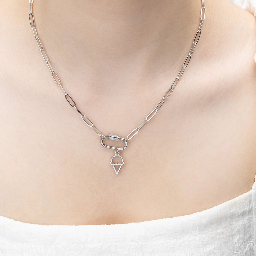 Silver chain necklace with a ice cream pendant on a person wearing a white top.
