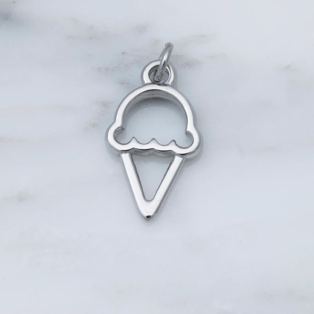 Silver ice cream cone pendant on a marble background