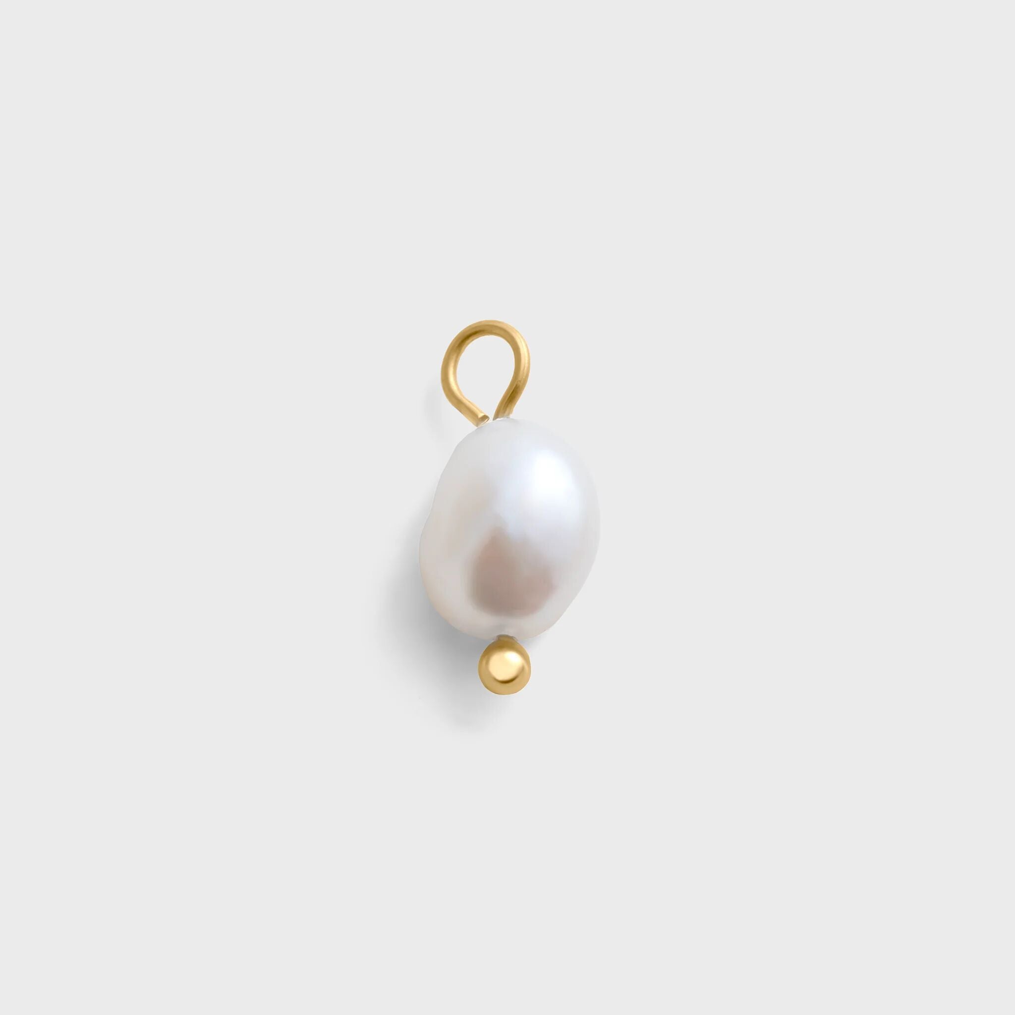 Pearl pendant with gold accents on a light gray background