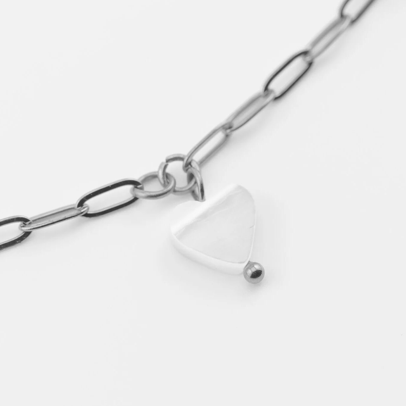 Silver chain with a heart pendant on a white background