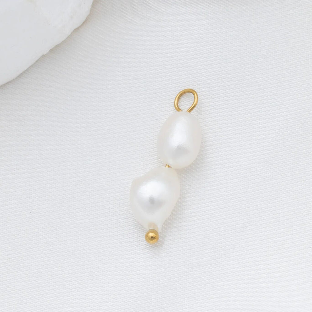 Pearl pendant with gold clasp on a white background