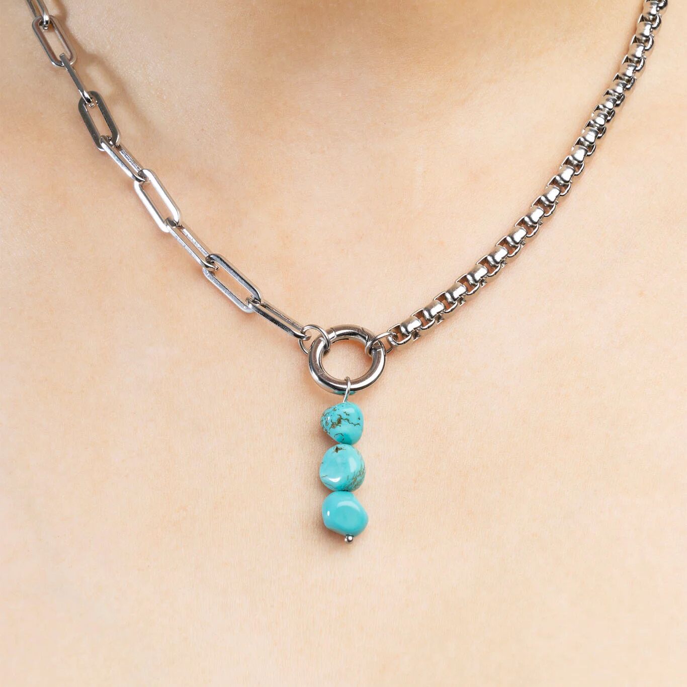 Necklace with turquoise beads on a plain background