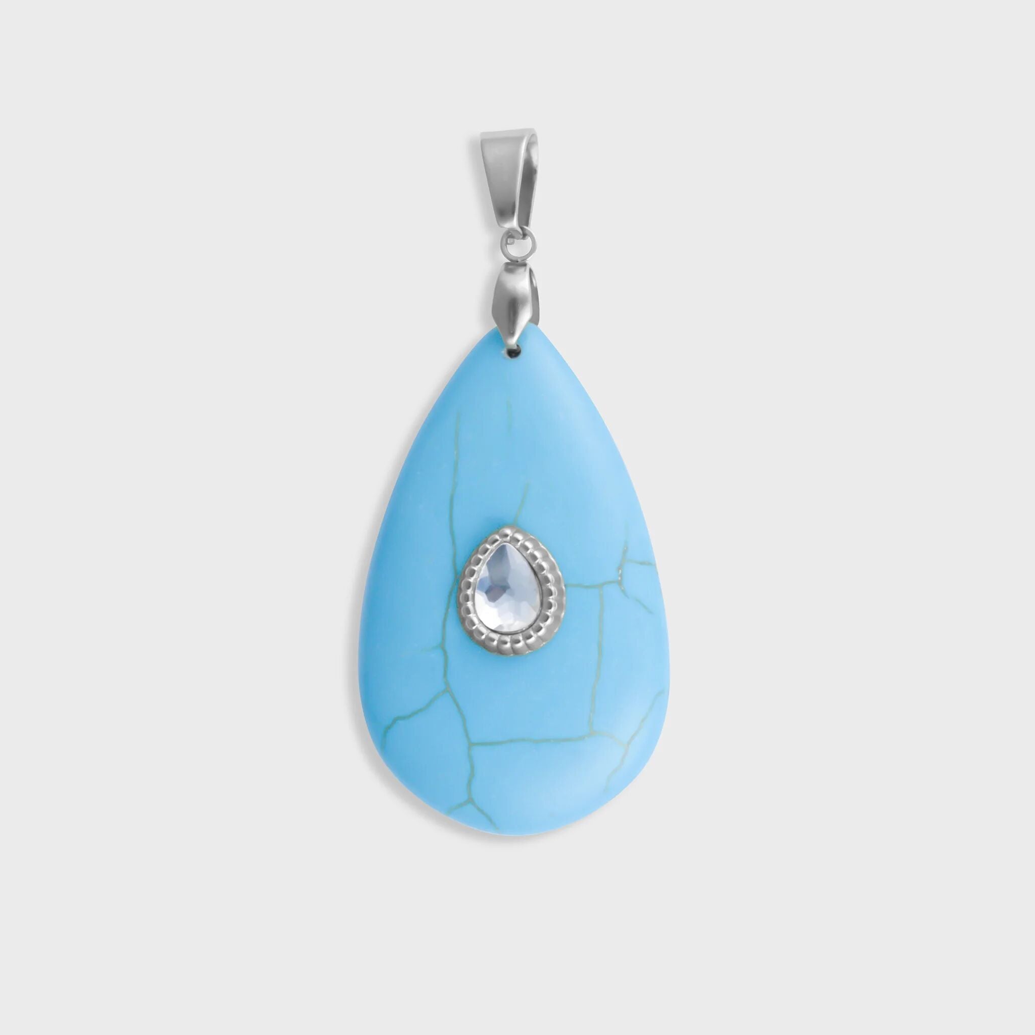 Turquoise pendant with a silver chain on a light gray background