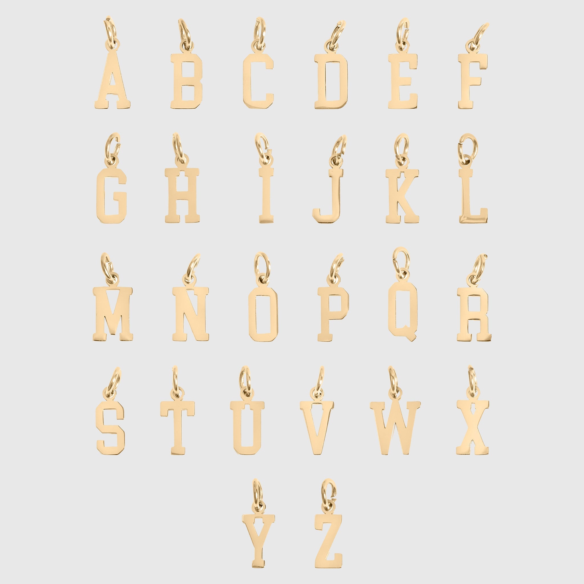 Gold letter pendants from A to Z on a light gray background