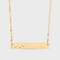 Gold necklace with star designs on a light gray background
