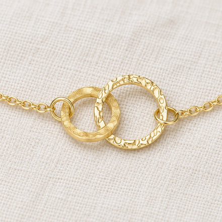 Amity Circle Bracelet — construction detail on ivory fabric; AI-generated supporting image.
