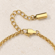 Celia Link Bracelet — gold lobster clasp and extension detail; AI-generated supporting image.