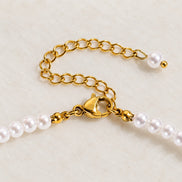 Iris Pearl Strand — gold clasp and pearl-tipped extension detail; AI-generated supporting image.