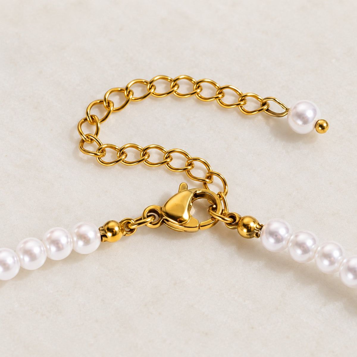 Iris Pearl Strand — gold clasp and pearl-tipped extension detail; AI-generated supporting image.