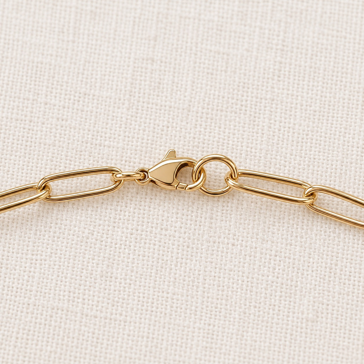Nora Paperclip Necklace — gold clasp and chain detail; AI-generated supporting image.