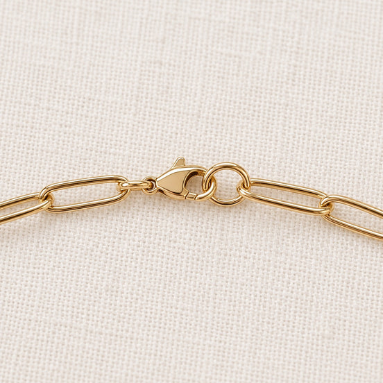 Nora Paperclip Necklace — gold clasp and chain detail; AI-generated supporting image.