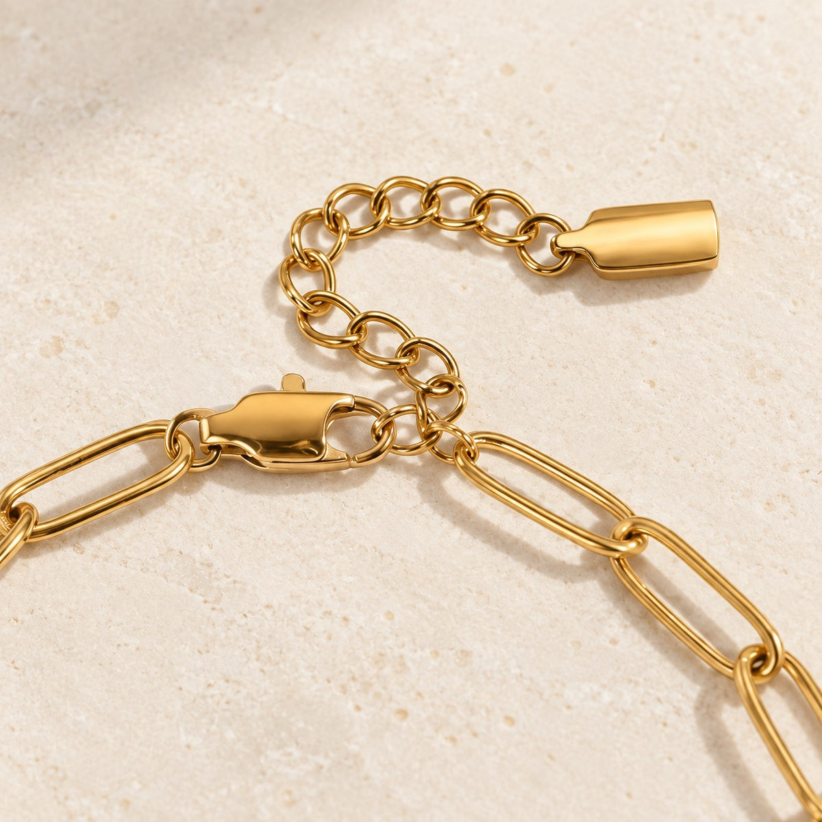 Nova Chain Bracelet in gold — lobster clasp and extension detail; AI-generated supporting image.