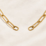 Nova Chain Bracelet in gold — separate oval connector ends and paperclip-link detail; AI-generated supporting image.