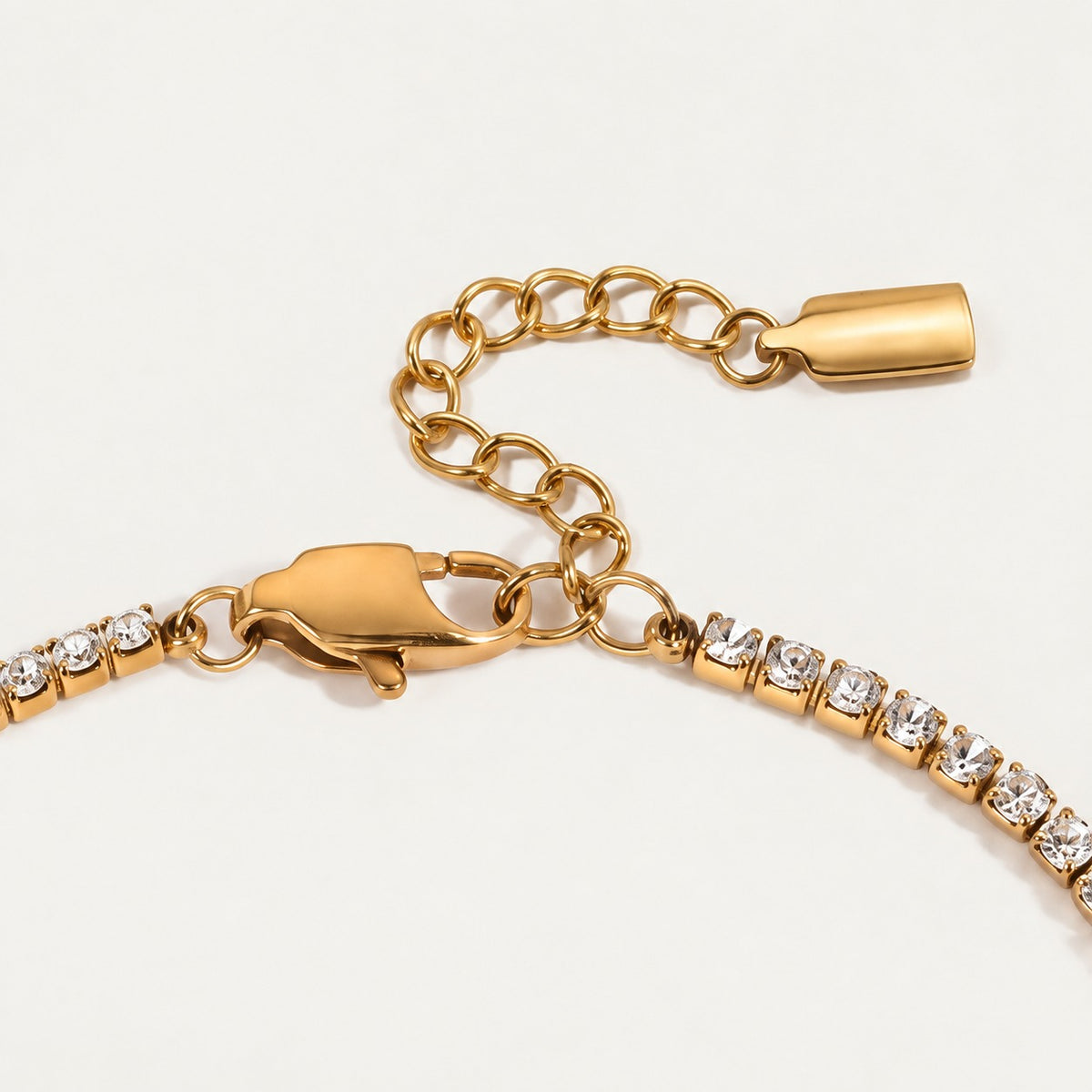 Rhea Link Bracelet — clasp detail, gold with clear round stones; AI-generated supporting image.