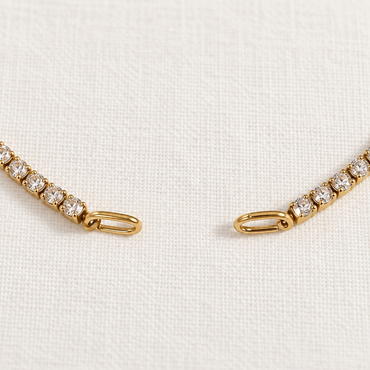 Rhea Link Bracelet — ends detail, gold with clear round stones; AI-generated supporting image.