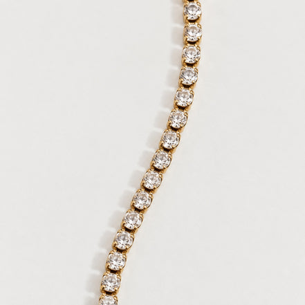 Rhea Link Bracelet — stones detail, gold with clear round stones; AI-generated supporting image.