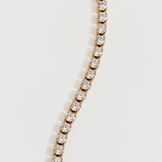 Rhea Link Bracelet — stones detail, gold with clear round stones; AI-generated supporting image.