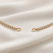 Rhea Link Necklace — ends detail, gold with clear round stones; AI-generated supporting image.