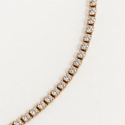 Rhea Link Necklace — stones detail, gold with clear round stones; AI-generated supporting image.