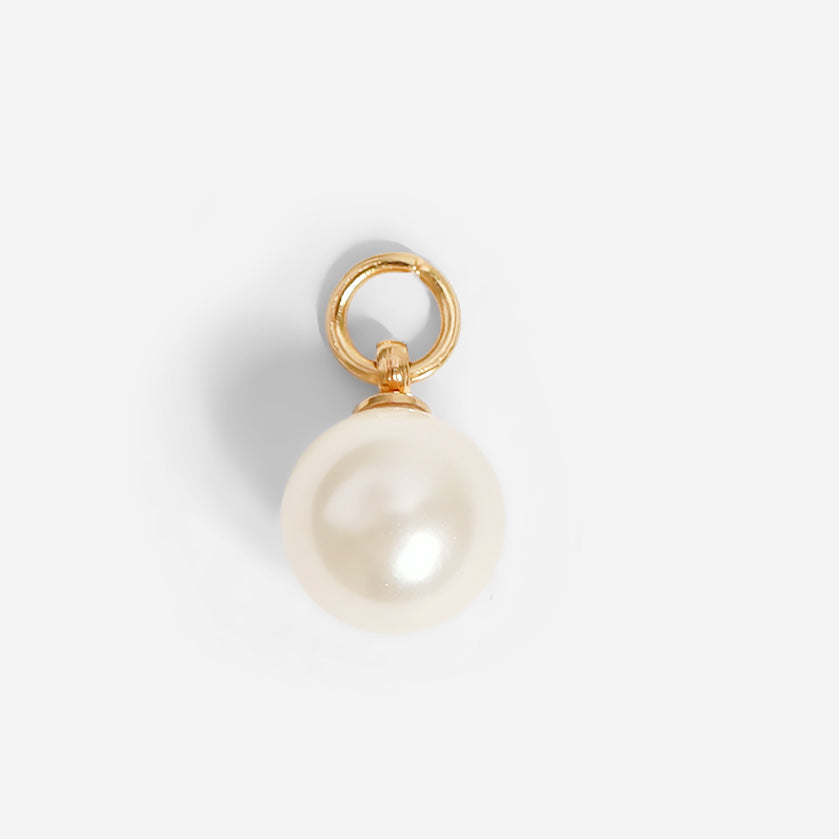 Pearl pendant with gold setting on a white background